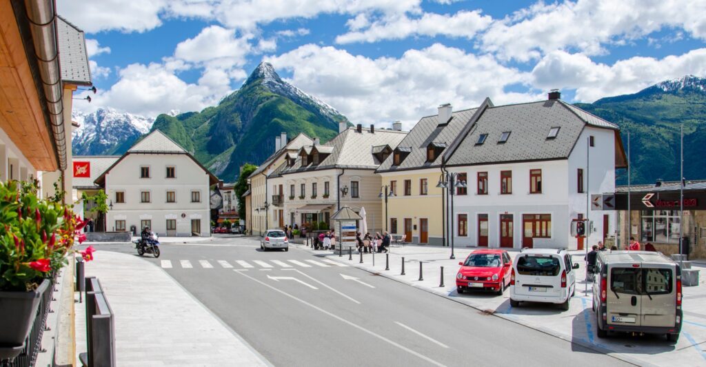 Main street of Bovec with a mountain peak behind