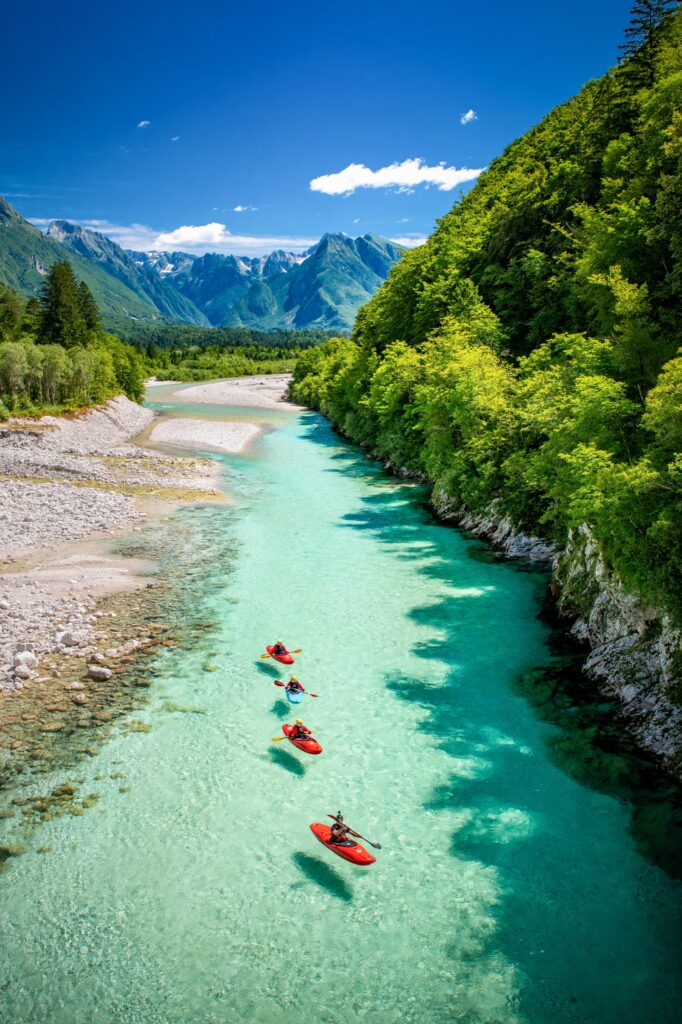 Kayakers on the emerald Soča River